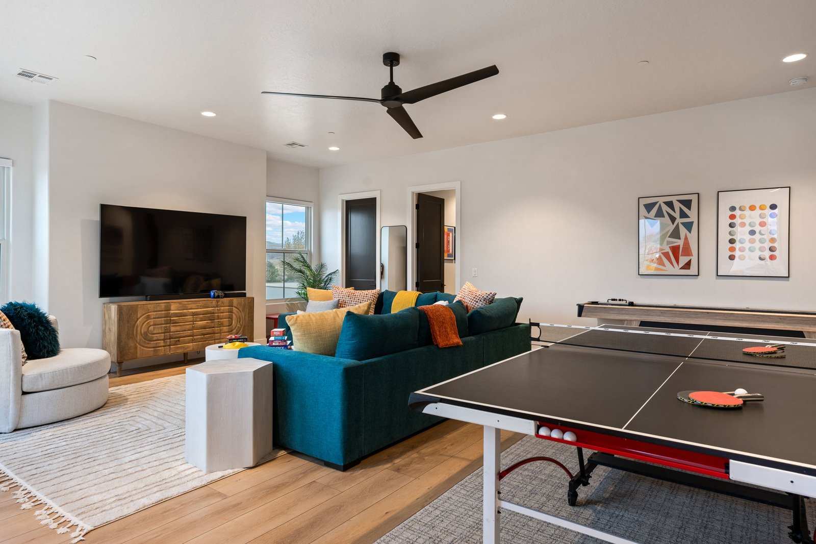 Color House family room with ping pong table, shuffleboard, big-screen TV and wraparound sectional