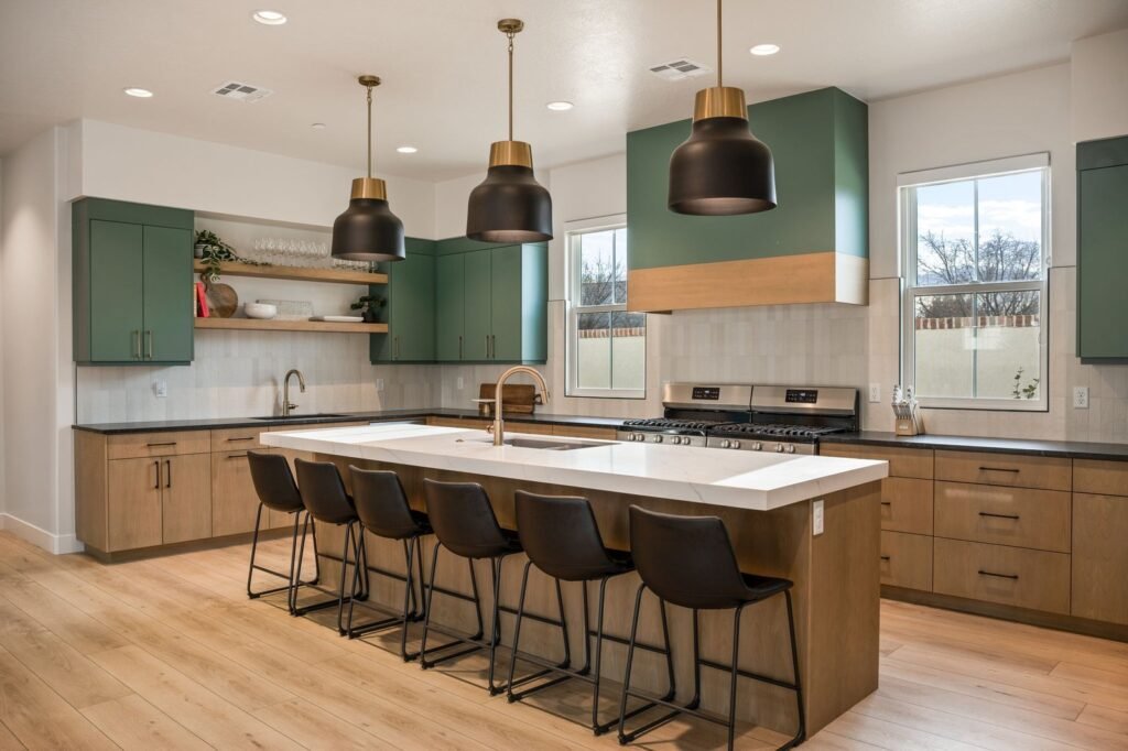 Chef’s kitchen with two ranges, green cabinets and island seating